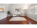Bright living room with hardwood floors, a large window, and tasteful decor at 13906 Jackson St, Thornton, CO 80602