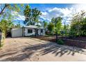 Exterior view of home with a private driveway and fenced-in yard, showcasing curb appeal at 2658 W 1St Ave, Denver, CO 80219