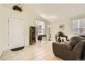 Bright living room with neutral tile flooring, large windows, and a comfortable sofa at 9882 Harris St, Thornton, CO 80229