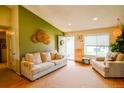 Cozy living room with large window, neutral colored furniture, and bright, airy atmosphere at 12498 W Prentice Dr, Littleton, CO 80127