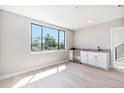 Bonus room with sleek cabinets, gray countertop, and a large window offering plenty of natural light at 2078 S Holly St # 1, Denver, CO 80222