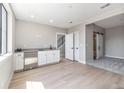 Finished bonus room features a bar area and access to a bedroom and stairs at 2078 S Holly St # 1, Denver, CO 80222