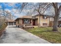 Charming brick home with mature trees, a front porch, a long driveway and a detached garage at 7930 Quitman St, Westminster, CO 80030