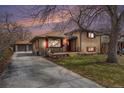Charming single-Gathering home with brick exterior, welcoming front porch, and long driveway to a detached garage at 7930 Quitman St, Westminster, CO 80030