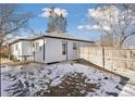 View of the back of the house and a fenced backyard at 1130 Oak Pl, Thornton, CO 80229