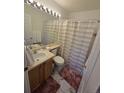 Clean bathroom with shower/tub combo, vanity, and updated flooring at 19877 E 40Th Ave, Denver, CO 80249