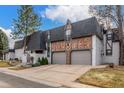 Exterior view showcasing attached garages with unique brick detailing and a well-maintained driveway at 3577 S Hillcrest Dr, Denver, CO 80237