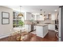 Bright kitchen with white cabinets, modern lighting, stainless steel appliances, and an adjacent dining area at 3577 S Hillcrest Dr, Denver, CO 80237