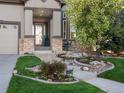 Inviting front yard with professional landscaping and a cozy porch at 10531 Lieter Pl, Lone Tree, CO 80124