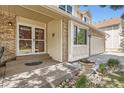 Close-up of the front porch, highlighting the entryway with decorative glass doors and stone landscaping at 5604 S Lisbon Way, Centennial, CO 80015