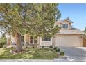 Inviting home with a well-kept lawn, mature tree, and a cozy front porch seating area at 5604 S Lisbon Way, Centennial, CO 80015