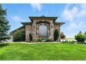 Attractive brick home with statues, garden beds, and lush lawn at 31200 E 145Th Ave, Brighton, CO 80603