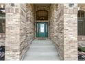Inviting entryway featuring a beautifully crafted front door and brick facade at 31200 E 145Th Ave, Brighton, CO 80603