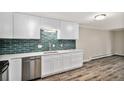 Well-lit kitchen boasts updated stainless steel appliances and modern finishes at 3460 S Poplar St # 404, Denver, CO 80224
