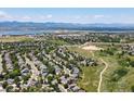 Scenic aerial view of a residential area near a lake, featuring winding roads and well-maintained homes at 2548 Foothills Canyon Ct, Highlands Ranch, CO 80129