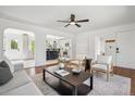 Bright and airy living room with hardwood floors and open concept to kitchen and dining at 1860 W Iris Cir, Littleton, CO 80120