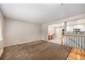 Spacious living room with a dining area that has a staircase in view at 12289 W Dakota Dr, Lakewood, CO 80228