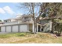 Charming two-story townhome with mature trees, three-car garage, and covered porch at 12560 E Warren Dr # E, Aurora, CO 80014