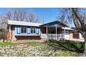 Charming single-Gathering home featuring a brick exterior, a cozy front porch with a white picket fence, and a well-manicured lawn at 921 S Wheeling St, Aurora, CO 80012