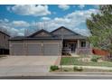 Charming single-Gathering home featuring a three-car garage, stone accents, and a well-maintained front yard at 16397 Sheridan Dr, Parker, CO 80134