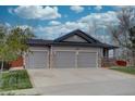 Spacious three-car garage providing ample parking and storage space, complimenting the home's exterior at 16397 Sheridan Dr, Parker, CO 80134