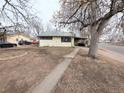 Quaint single-story home with a covered carport and a mature tree in the front yard at 2696 S Grove St, Denver, CO 80219