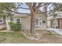 Charming home exterior featuring a large tree, bay window, and a lovely front yard at 9689 W Chatfield Ave # H, Littleton, CO 80128