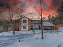 Two-story home with charming facade, surrounded by snowy landscape at 757 N Bluff Dr, Franktown, CO 80116