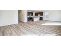 Open concept kitchen with island and dark cabinets at 13432 E 110Th Way, Commerce City, CO 80022