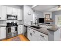 Updated kitchen featuring sleek stainless steel appliances, granite counters, and a modern backsplash design at 4385 S Balsam St # 10-103, Littleton, CO 80123