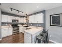 Modern kitchen with white cabinets, stainless steel appliances, and breakfast bar at 2900 Purcell St # F1, Brighton, CO 80601