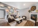 Comfortable living room with vaulted ceiling, fireplace and hardwood floors at 2900 Purcell St # F1, Brighton, CO 80601