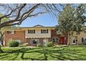 Charming townhome with red brick, neutral siding, and well-maintained front lawn and bushes at 12455 W Alameda Dr, Lakewood, CO 80228