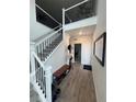 Open staircase and entryway with wood-look floors at 15682 W Girard Ave, Morrison, CO 80465