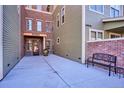 Side entrance to building with brick accents and bench at 5592 S Nevada St # 306, Littleton, CO 80120