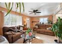 Comfortable living room with plush sofas, a ceiling fan, and natural light, creating a welcoming atmosphere at 6267 Fenton St, Arvada, CO 80003
