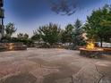 Expansive flagstone patio with fire pit and built-in seating at 2635 Spruce Meadows Dr, Broomfield, CO 80023