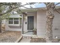 Close up of the home's entry featuring a secure door and a small bench at 1201 Moline St, Aurora, CO 80010