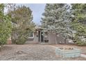 Cozy single-story home featuring mature trees and a walkway leading to the entrance at 1201 Moline St, Aurora, CO 80010