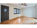 Bright living room with hardwood floors, ceiling fan, and a decorative bay window at 1201 Moline St, Aurora, CO 80010