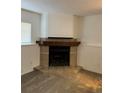 Cozy fireplace with tile surround, wood mantle, and neutral carpet in a living space at 4296 S Halifax Way, Aurora, CO 80013