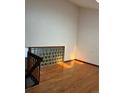 Bright hallway featuring wood floors and a decorative glass block wall beneath a high ceiling at 4296 S Halifax Way, Aurora, CO 80013