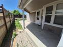 Covered patio area with concrete flooring and a wooden fence, perfect for outdoor relaxation at 4296 S Halifax Way, Aurora, CO 80013