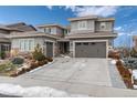 Stunning two-story home with a large driveway and landscaped front yard at 10841 Greycliffe Dr, Highlands Ranch, CO 80126