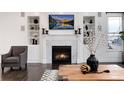 Elegant living room featuring a marble fireplace and built-in shelving at 10841 Greycliffe Dr, Highlands Ranch, CO 80126