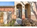 Charming entrance to this townhouse features brick accents, a covered entryway, and clear unit number signage at 290 Poplar St # A, Denver, CO 80220