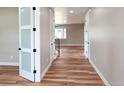 Bright hallway featuring wood floors and white doors leading into other rooms at 5550 Wetlands Dr, Longmont, CO 80504