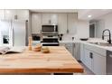 Stylish kitchen features stainless steel appliances and a butcher block island at 1020 Stuart St, Denver, CO 80204