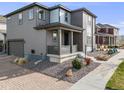 Charming two-story home featuring brick and siding, an attached garage and cozy front porch at 9694 Meeker St, Littleton, CO 80125
