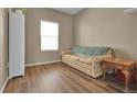 Cozy living room featuring wood floors, neutral walls, a large window, and comfortable seating at 7131 Shavano Cir, Frederick, CO 80504